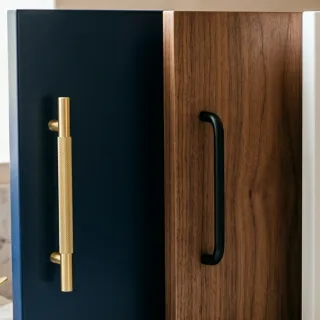 Navy and walnut cabinet door samples with brass and black handles